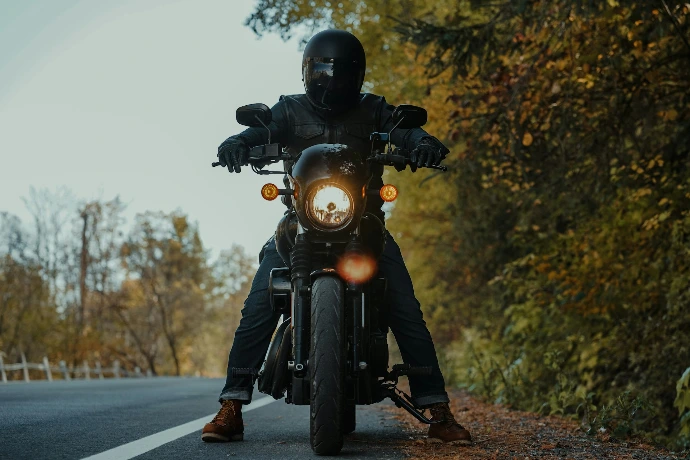 a man riding a motorcycle down a curvy road